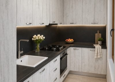 Bucatarie in L cu fronturi imitatie beton albit, blat gri inchis, spate negru si chiuveta ceramica alba