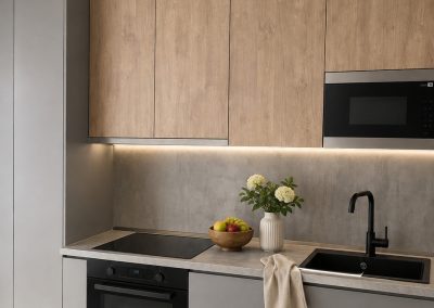 Bucătărie liniară la comandă cu corpuri sus în decor stejar și corpuri jos gri mat fără mânere, blat imitație beton și chiuvetă neagră